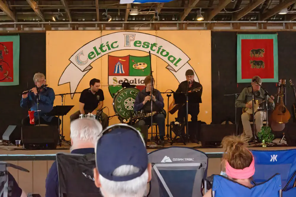 Musicians performing on the Sedalia Celtic Festival stage before a seated audience